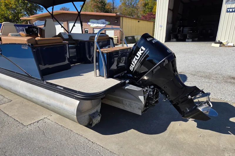 Slide: The Image of 2023 Avalon Platinum 2385 Catalina Quad Lounger with Suzuki outboard motor, docked outdoors. - 5