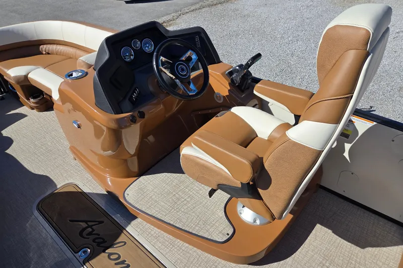 Slide: The Image of 2023 Avalon Platinum 2385 Catalina Quad Lounger interior with tan and white seating. - 8