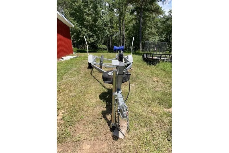 Slide: The Image of Trailer for 2009 Pro-Line Pro Lite 20 CC on grassy area near red building. - 13