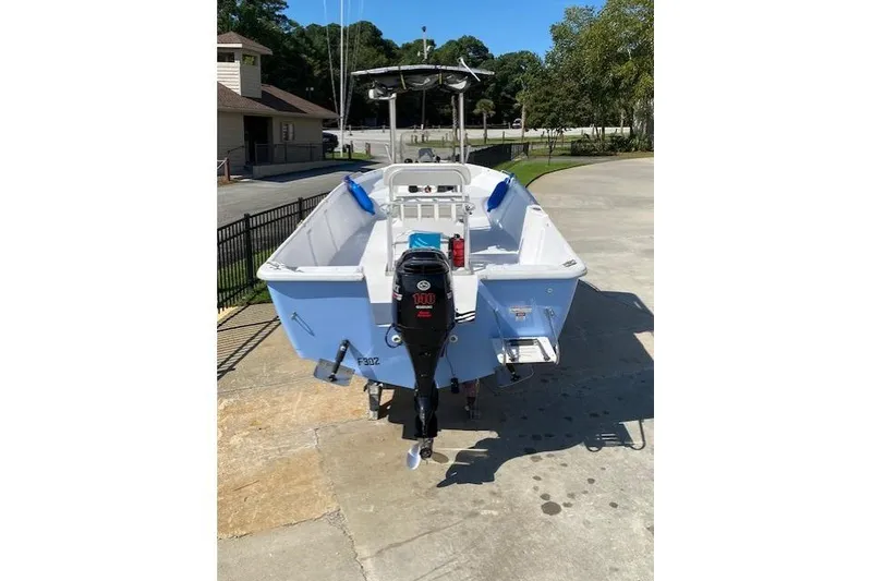 Slide: The Image of 2009 PRO LITE 20 CC boat with outboard motor, parked on concrete surface. - 4