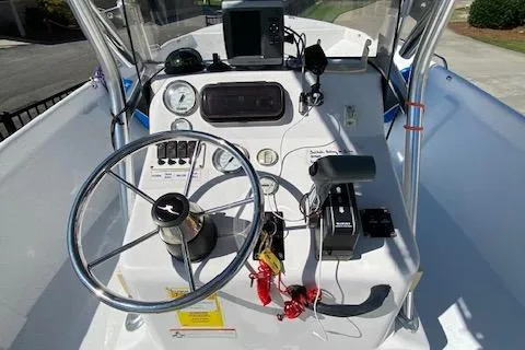 Slide: The Image of 2009 PRO LITE 20 CC boat dashboard with steering wheel and navigation controls. - 5