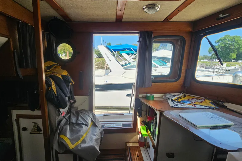 Slide: The Image of Interior of a 1982 Nordic Tug 26 with marina view through windows. - 18