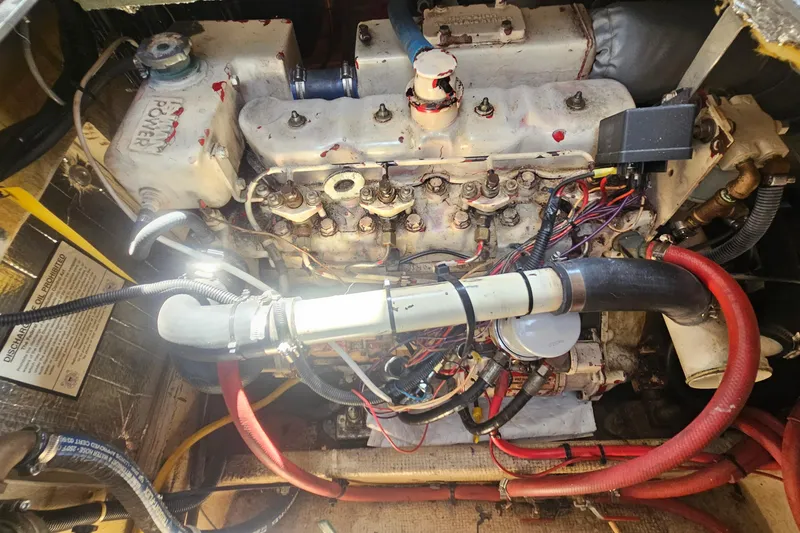 Slide: The Image of Engine compartment of a 1982 Nordic Tug 26, showcasing detailed mechanical components. - 26