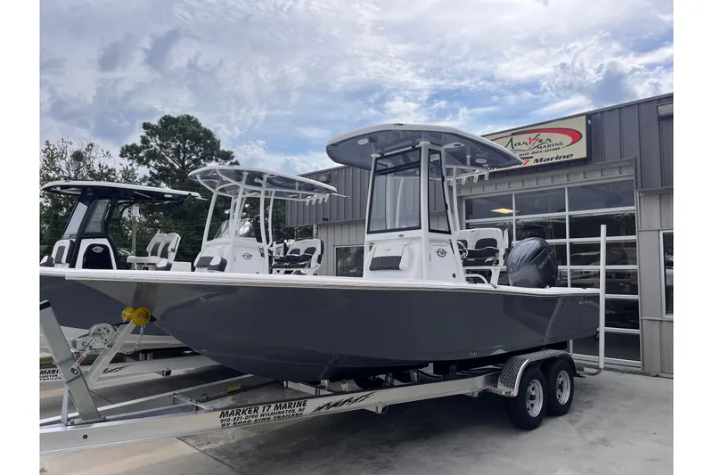 Slide: The Image of 2026 Tidewater 2210 Carolina Bay boat on trailer outside dealership. - 1