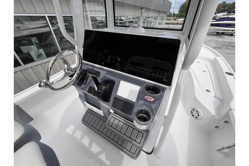 Slide: The Image of 2026 Tidewater 2210 Carolina Bay boat console with steering wheel and controls. - 10