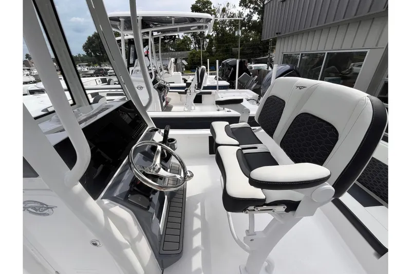 Slide: The Image of 2026 Tidewater 2210 Carolina Bay boat interior with modern steering and seating. - 11