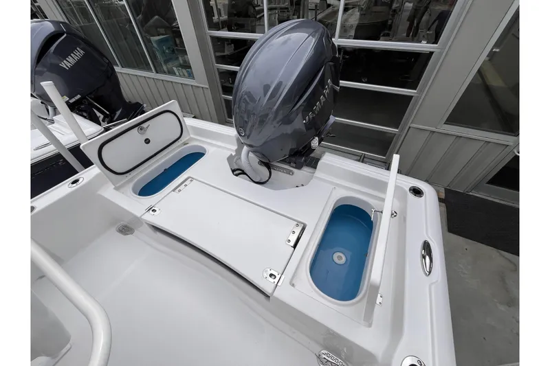 Slide: The Image of 2026 Tidewater 2210 Carolina Bay boat with Yamaha outboard motor, featuring storage compartments. - 12