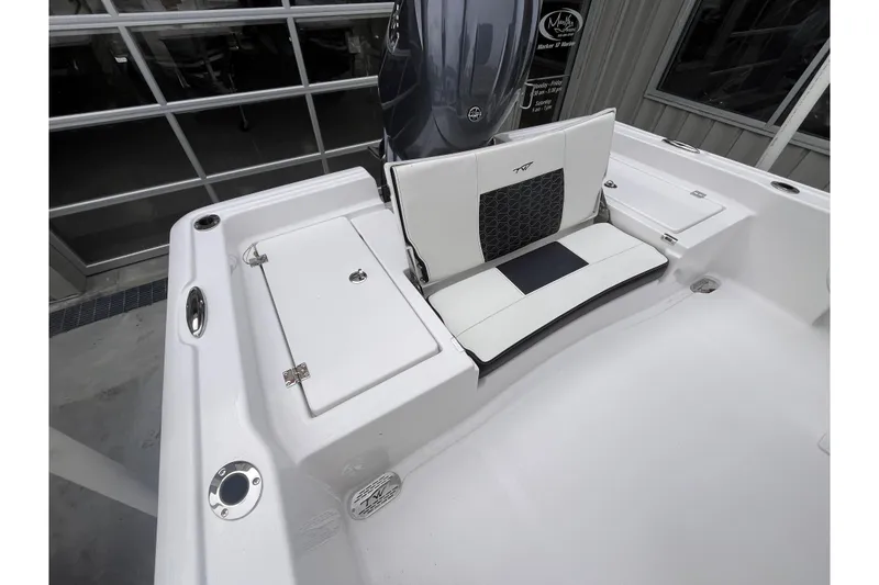 Slide: The Image of 2026 Tidewater 2210 Carolina Bay boat interior with seating and storage compartments. - 3
