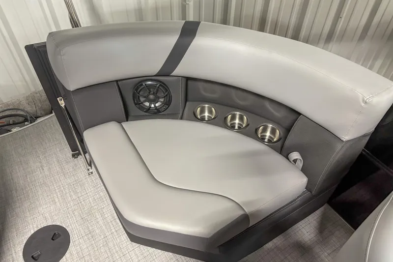 Slide: The Image of 2025 Trifecta 24 E CS boat interior with cushioned seating and built-in cup holders. - 10