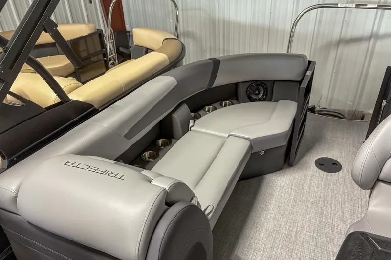 Slide: The Image of 2025 Trifecta 24 E CS pontoon boat interior with luxurious seating and cup holders. - 11