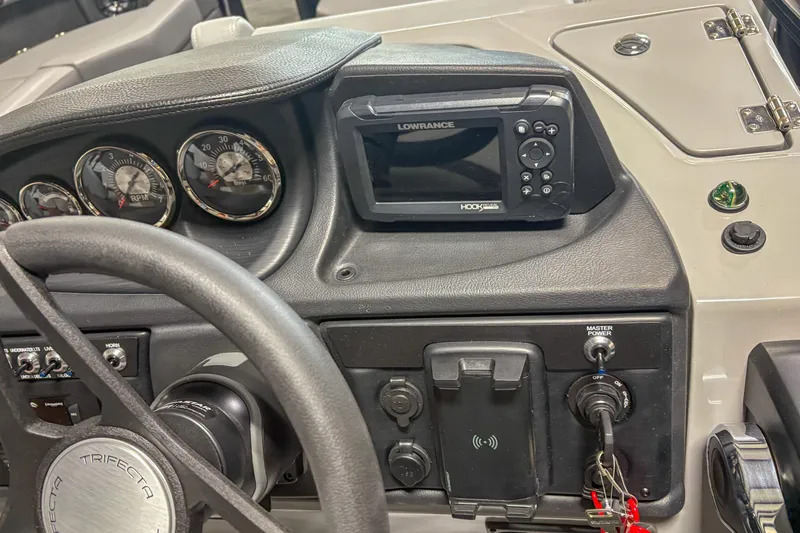 Slide: The Image of Dashboard of 2025 Trifecta 24 E CS with steering wheel and navigation system. - 12