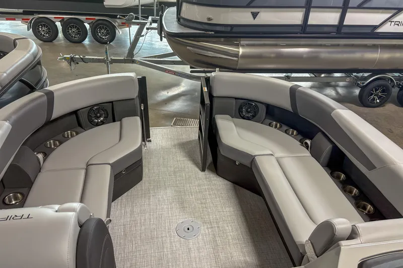 Slide: The Image of 2025 Trifecta 24 E CS pontoon boat interior with plush seating and cup holders. - 3