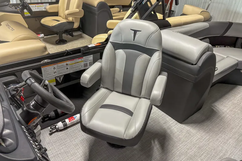 Slide: The Image of 2025 Trifecta 24 E CS boat interior with luxurious seating and steering wheel. - 4