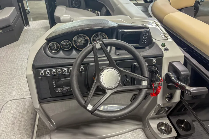 Slide: The Image of 2025 Trifecta 24 E CS boat dashboard with steering wheel and control panel. - 5