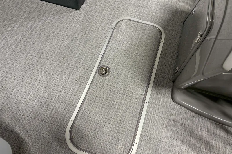 Slide: The Image of 2025 Trifecta 24 E CS boat interior with sleek flooring and storage compartment. - 6