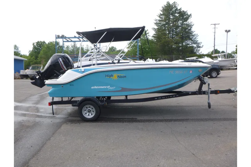 The Image of 2022 Bayliner Element M17 boat on trailer, blue hull, parked outdoors. - 1