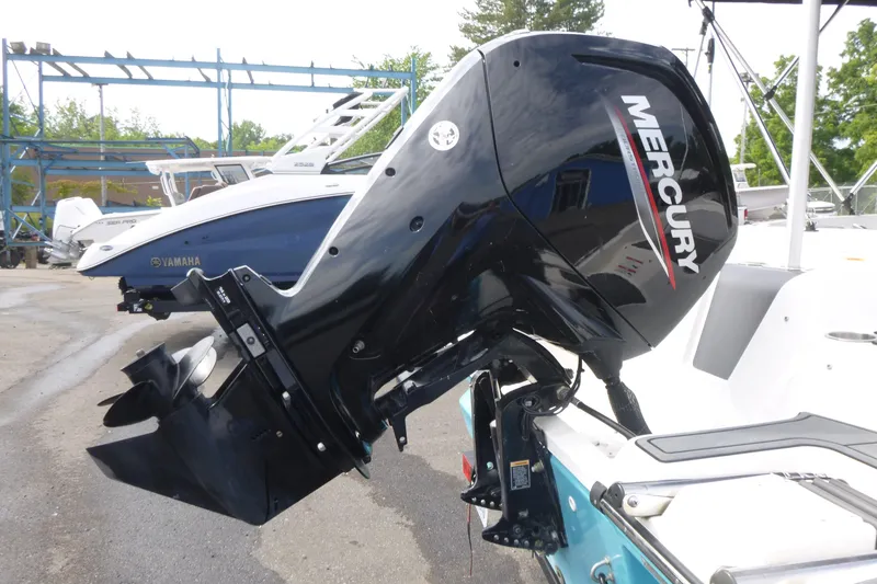 Slide: The Image of 2022 Bayliner Element M17 with Mercury outboard motor in a marina setting. - 13