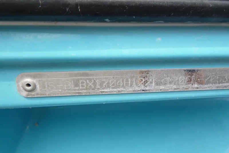 Slide: The Image of 2022 Bayliner Element M17 hull identification number on blue surface. - 15