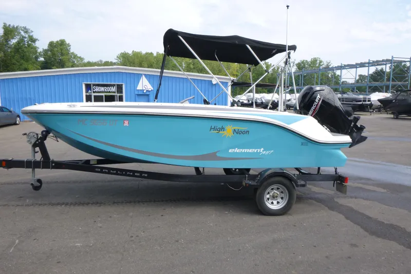 Slide: The Image of 2022 Bayliner Element M17 boat on trailer, blue exterior, parked near showroom. - 4