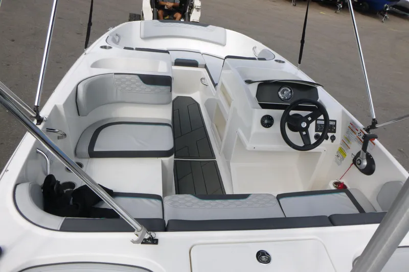 Slide: The Image of 2022 Bayliner Element M17 boat interior with seating and steering console. - 5