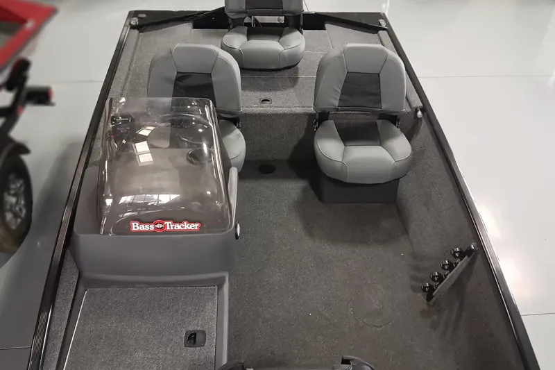 Slide: The Image of 2025 Tracker Bass Tracker Classic XL boat interior with three gray seats and steering console. - 12