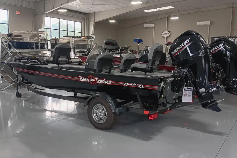 Slide: The Image of 2025 Tracker Bass Tracker Classic XL boat with Mercury engines in showroom. - 3