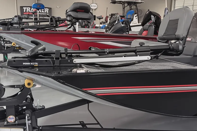 Slide: The Image of 2025 Tracker Bass Tracker Classic XL boat with Minn Kota trolling motor in showroom. - 7