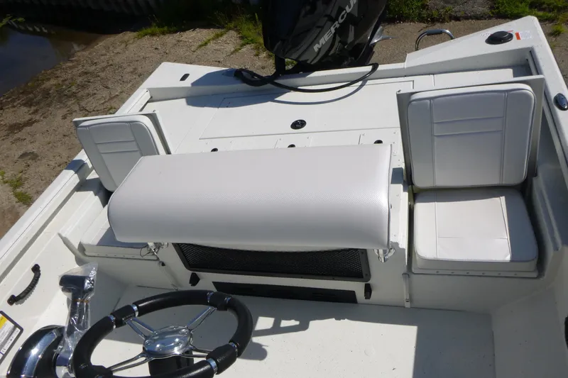 Slide: The Image of 2025 Ranger RB210 boat interior with white seating and steering wheel. - 16
