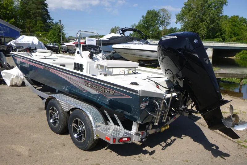 Slide: The Image of 2025 Ranger RB210 boat with outboard motor on trailer, parked outdoors. - 3