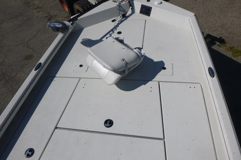 Slide: The Image of 2025 Ranger RB210 boat deck with white seat and storage compartments. - 7