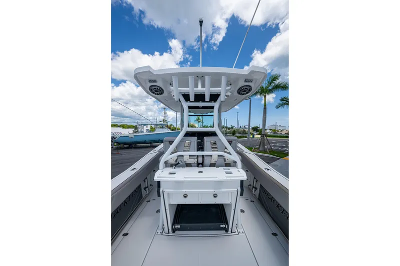 Slide: The Image of 2019 Blackfin 272 CC boat deck with T-top and clear sky background. - 10