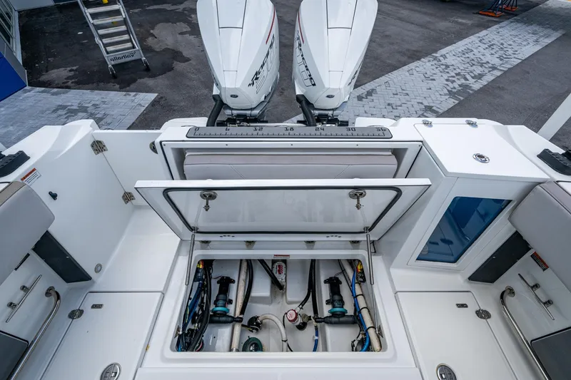 Slide: The Image of 2019 Blackfin 272 CC boat with open hatch and dual outboard engines. - 14