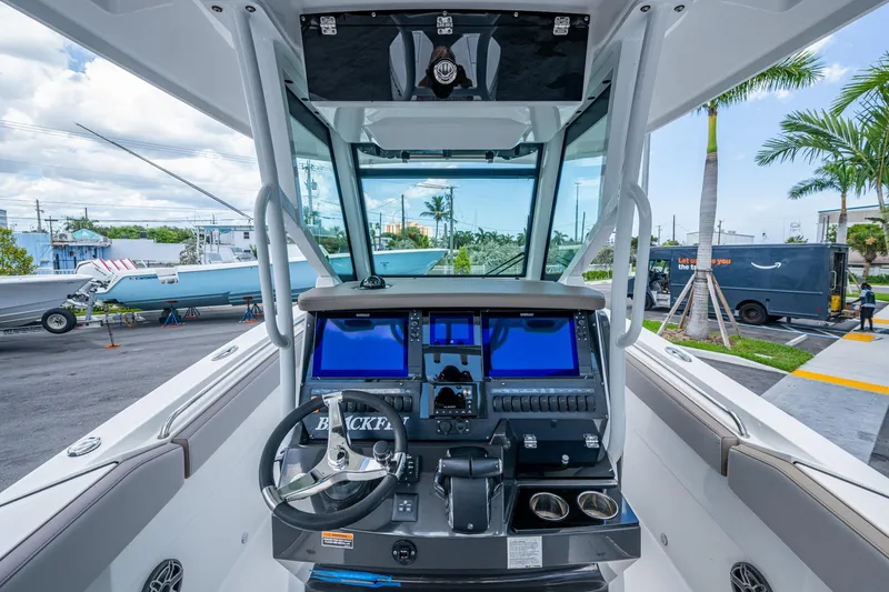 Slide: The Image of 2019 Blackfin 272 CC boat cockpit with modern navigation system and steering wheel. - 17