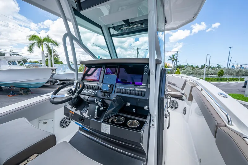 Slide: The Image of 2019 Blackfin 272 CC boat cockpit with modern navigation system and comfortable seating. - 18