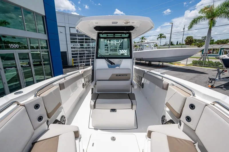 Slide: The Image of 2019 Blackfin 272 CC boat interior with seating, docked near dealership. - 24