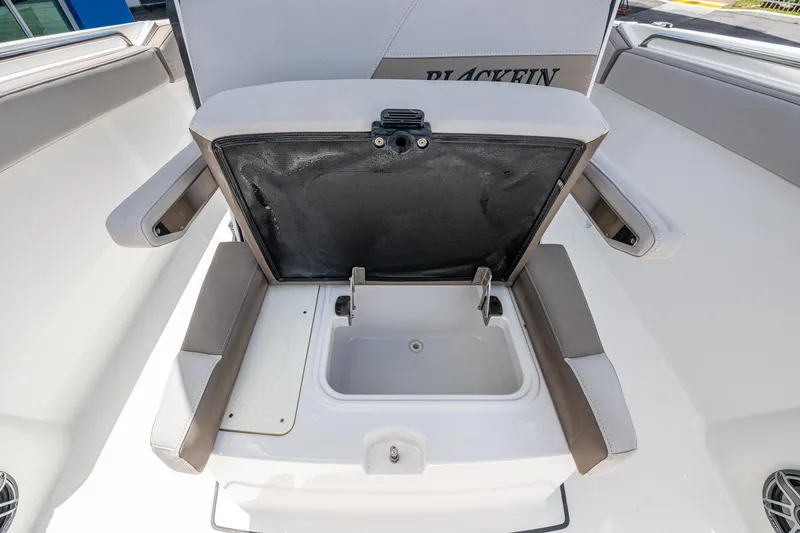 Slide: The Image of 2019 Blackfin 272 CC boat seat with open storage compartment. - 25