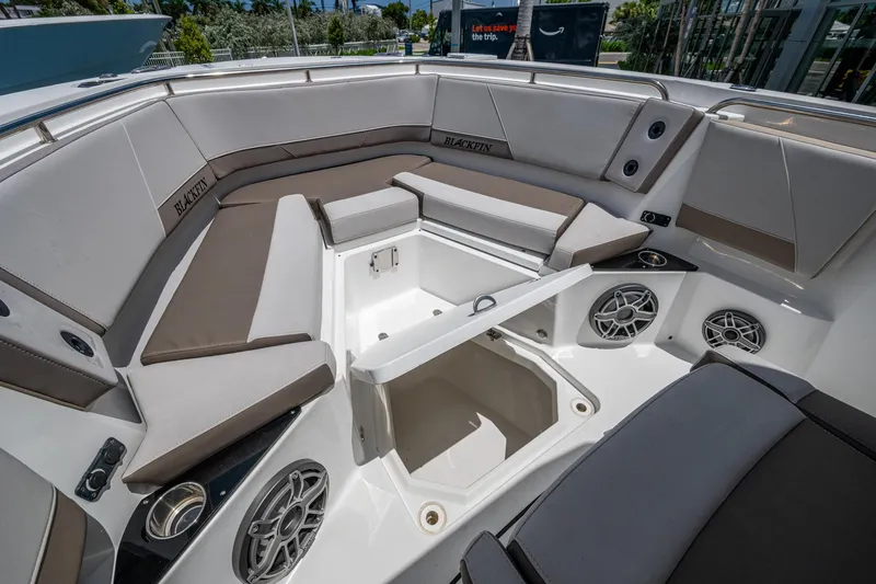 Slide: The Image of 2019 Blackfin 272 CC boat interior with cushioned seating and storage compartment. - 26