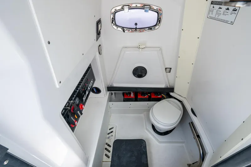 Slide: The Image of 2019 Blackfin 272 CC boat interior with control panel and marine toilet. - 29