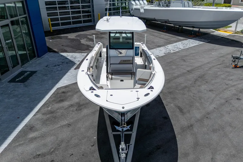 Slide: The Image of 2019 Blackfin 272 CC boat displayed outdoors at a dealership. - 3