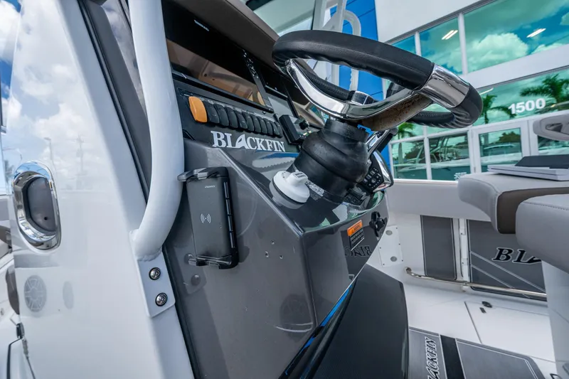 Slide: The Image of 2019 Blackfin 272 CC boat steering console with modern controls and sleek design. - 33