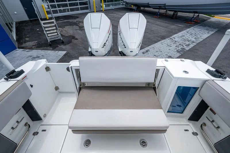 Slide: The Image of 2019 Blackfin 272 CC boat interior with seating and dual outboard engines. - 35