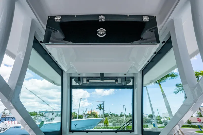 Slide: The Image of Interior view of 2019 Blackfin 272 CC boat with clear windows and storage compartment. - 36