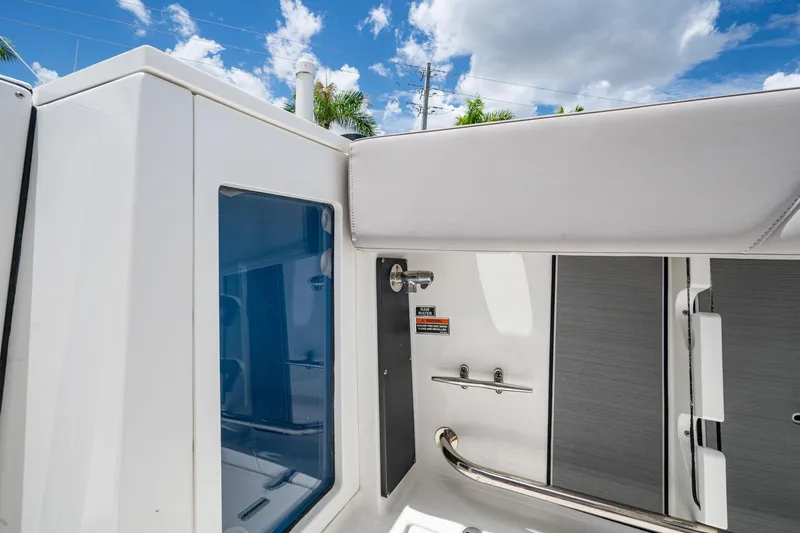 Slide: The Image of 2019 Blackfin 272 CC boat interior with sleek design and modern features under a blue sky. - 39