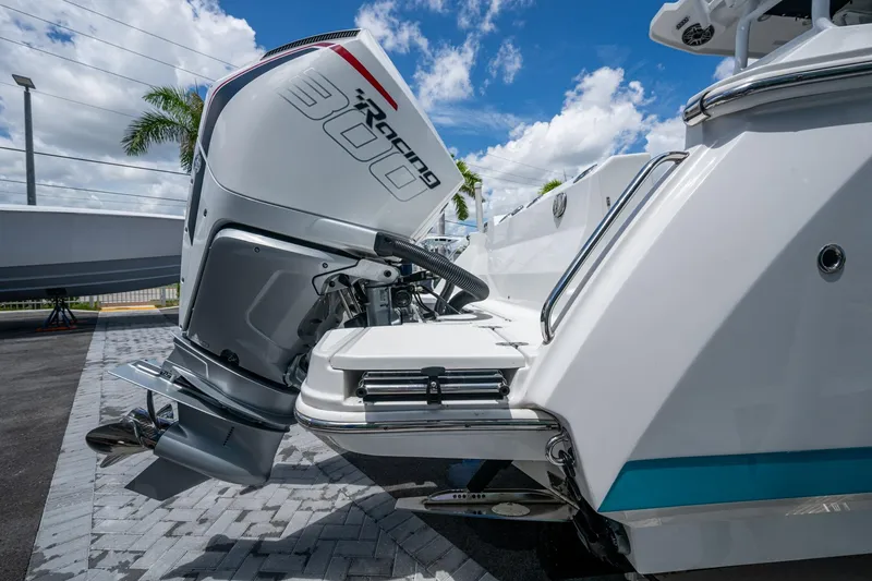 Slide: The Image of 2019 Blackfin 272 CC boat with powerful outboard motor, parked under a clear blue sky. - 52