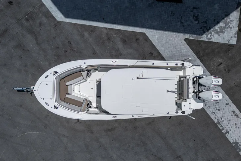 Slide: The Image of Aerial view of 2019 Blackfin 272 CC boat with twin engines on a paved surface. - 7
