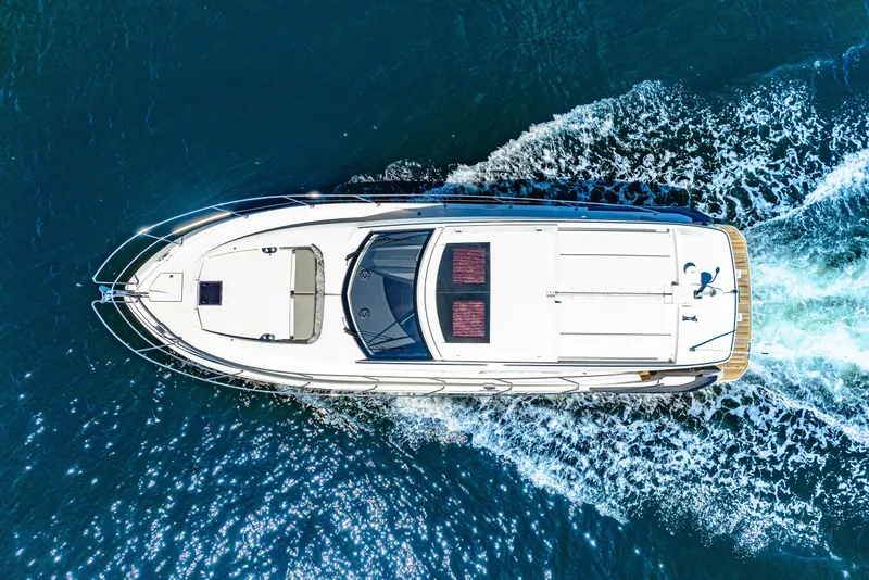 Slide: The Image of Aerial view of 2024 Beneteau Gran Turismo 45 yacht cruising on blue water. - 11