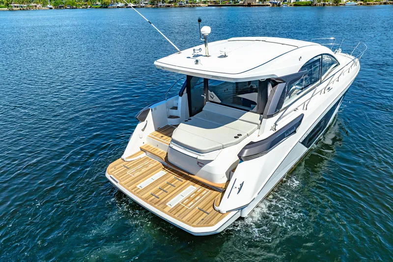 Slide: The Image of 2024 Beneteau Gran Turismo 45 yacht cruising on a serene blue lake. - 19