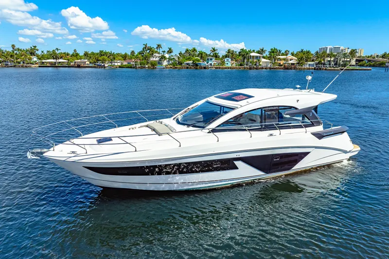 Slide: The Image of 2024 Beneteau Gran Turismo 45 yacht cruising on a sunny day, surrounded by calm waters. - 3