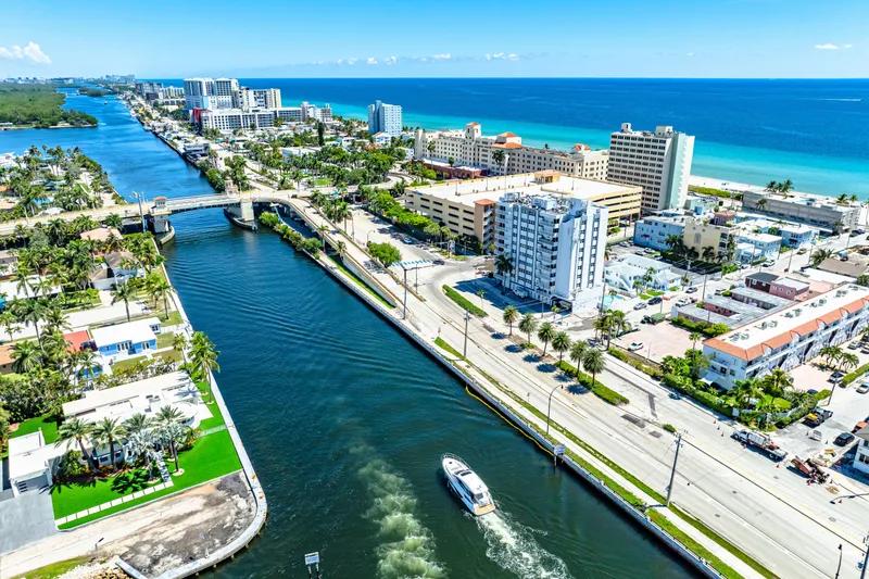 Slide: The Image of Aerial view of 2024 Beneteau Gran Turismo 45 cruising through a coastal city canal. - 30