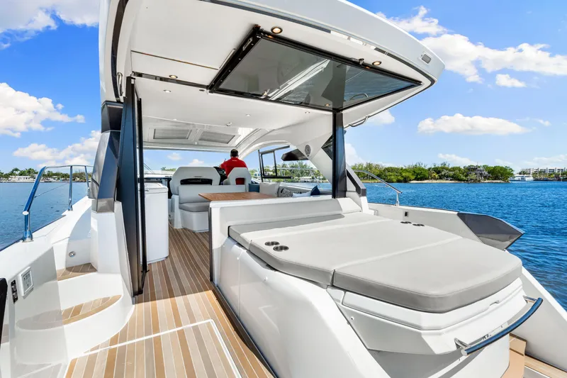 Slide: The Image of 2024 Beneteau Gran Turismo 45 yacht with spacious deck and luxurious seating on a sunny day. - 31